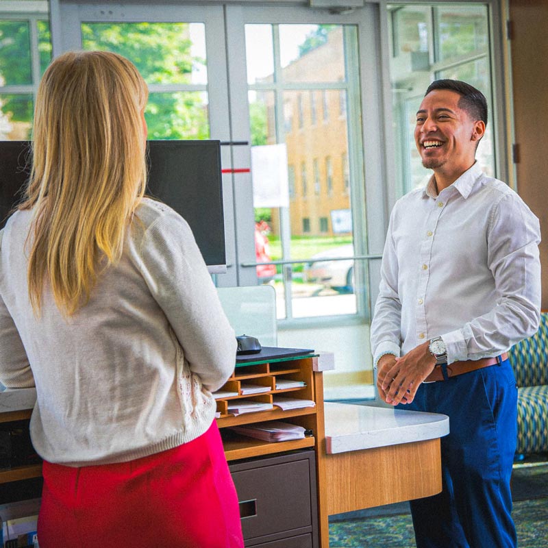 Image - A bank employee speaking with a customer.