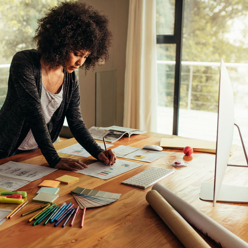 Image - Woman marking design plans.